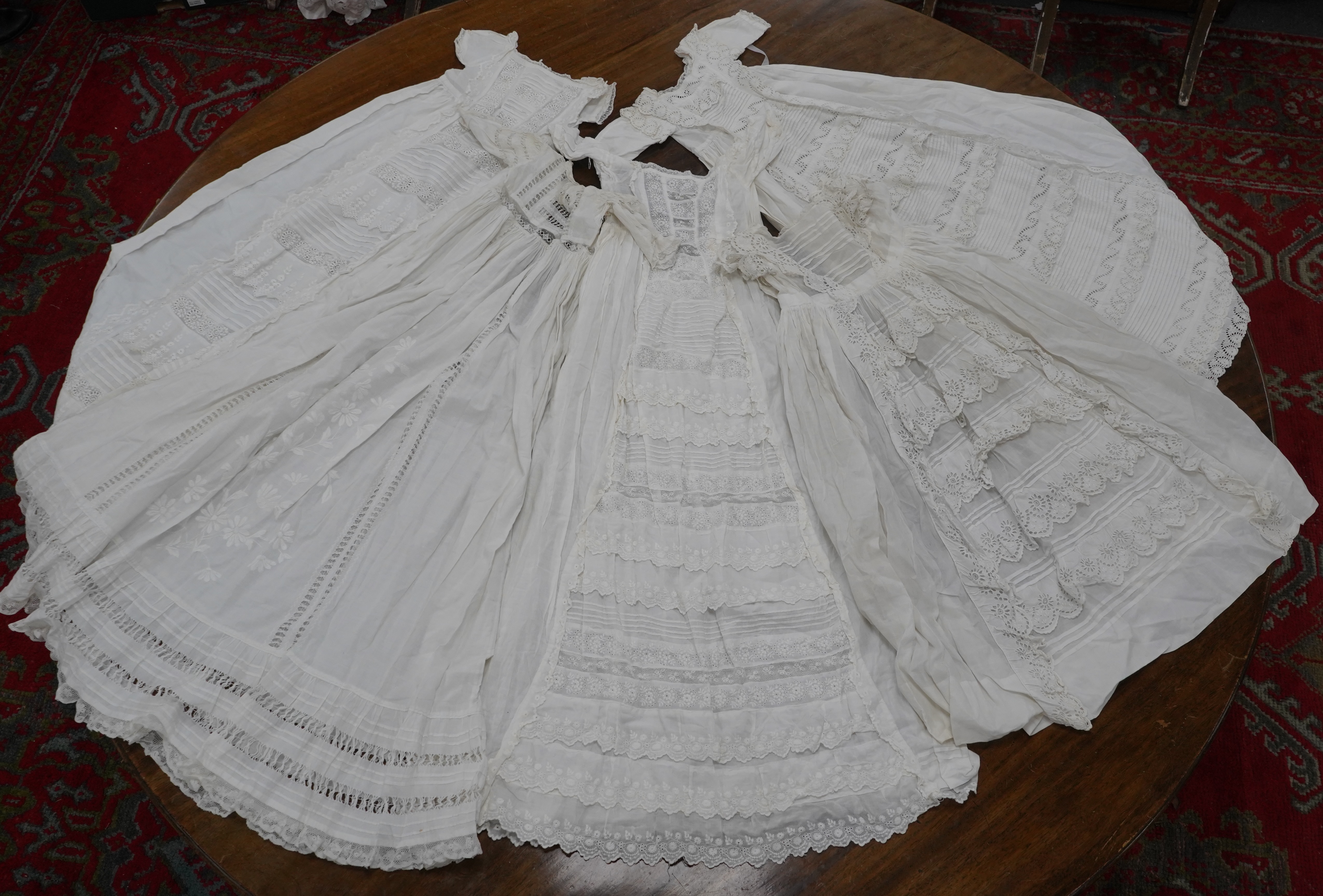 Five Victorian white worked fine cotton and lawn baby’s christening gowns. mostly worked with embroidery anglaise, feather stitching, tucking, drawn thread work and lace edging, longest 41cm. Condition - in good conditio